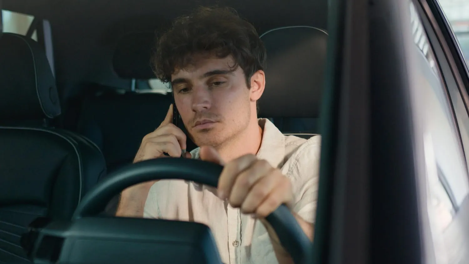 man talking on the phone in car