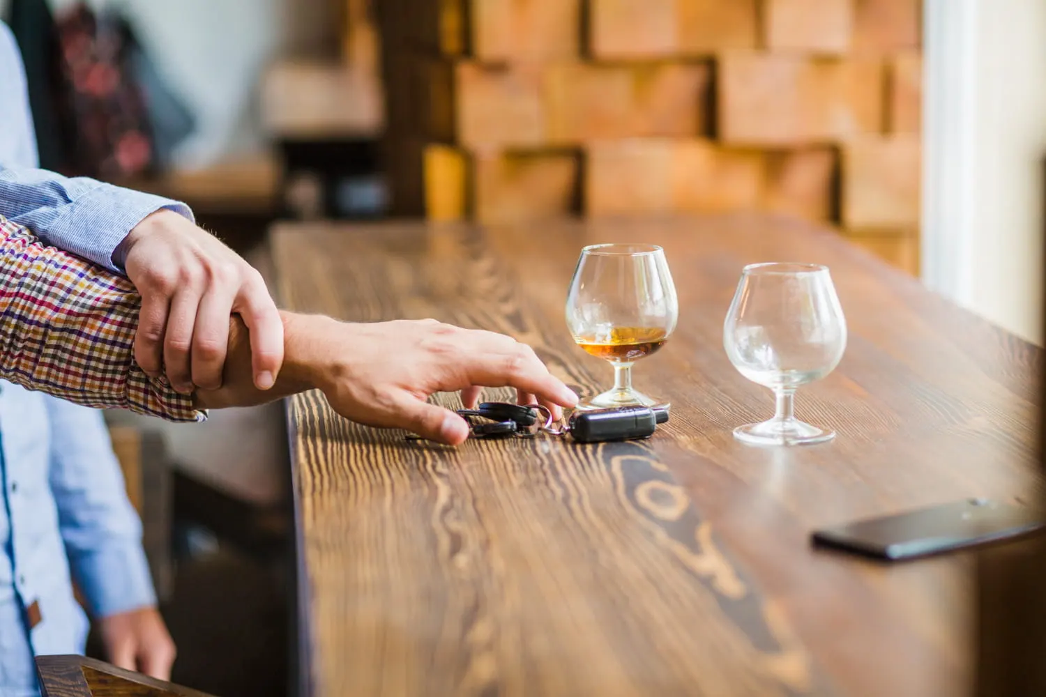 hand stopping someone from drinking