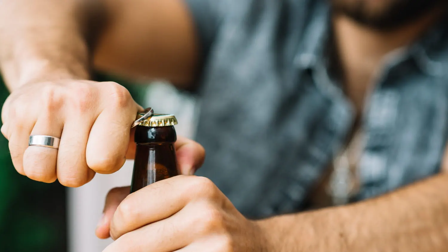 man opening a beer bottle