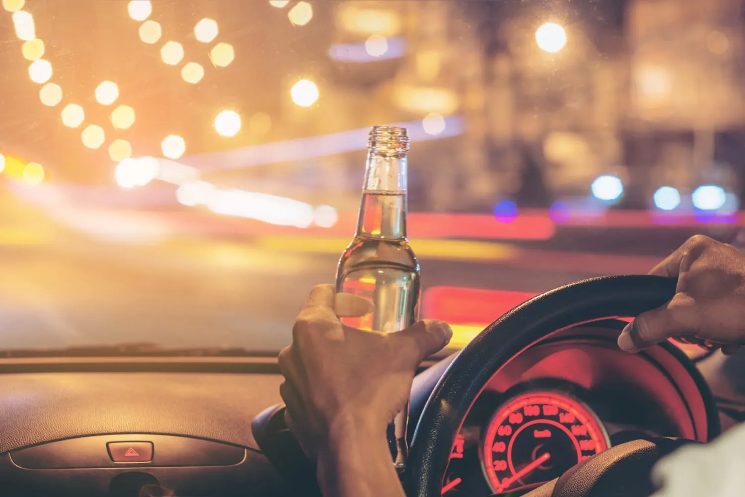 man drinking behind steering wheel
