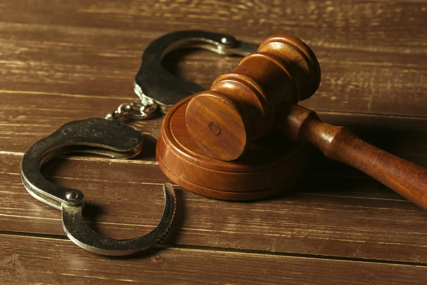 judge's gavel near handcuffs